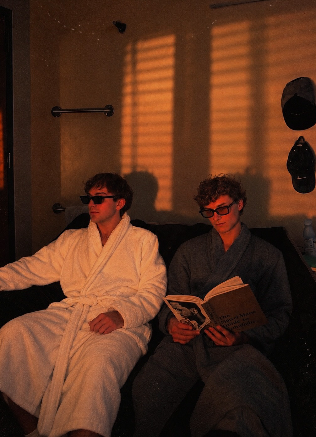 SOMA in bathrobes as golden light falls through window blinds